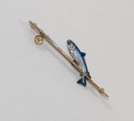 An enamelled bar brooch in the form of a leaping salmon and fishing rod,