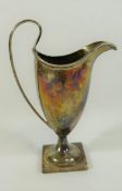 An Edwardian silver helmet shaped cream jug, London 1901, with reeded handle on square base, 14.