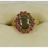 A yellow metal oval gem set cluster ring, stamped '18K', finger size M, 4.