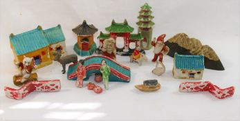 An early 20th century Japanese bisque porcelain miniature garden set including buildings, Koi carp,