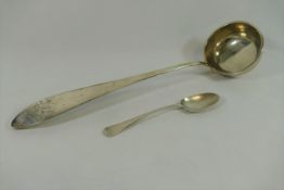 A large 18th century German silver soup ladle, with armorial engraving, 38cm long, 7.54ozt, 234.