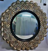 A 20th century circular convex mirror, 44cm diameter, with shell frame,