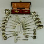 Assorted silver cutlery including a silver sauce ladle, sugar nips, salt and mustard spoons,