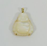 A yellow metal mounted carved mother of pearl Buddha pendant, stamped '14K', 3.