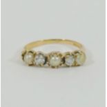 A yellow metal pearl and diamond five-stone ring, the two old cut diamonds approximately 0.