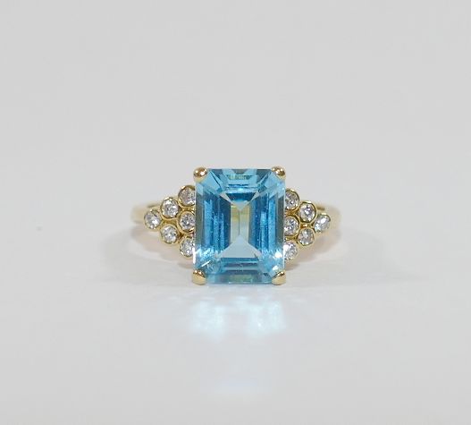 An 18 carat gold blue topaz and diamond ring,