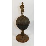 An 18th century painted cast iron and bronze pedestal cup and cover, with figural finial,