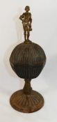 An 18th century painted cast iron and bronze pedestal cup and cover, with figural finial,