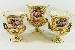 A garniture of three early 19th century Derby porcelain two-handled vases, of campagna form,