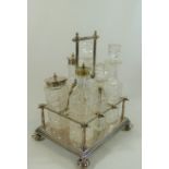 A Victorian silver plated six bottle cruet stand, of rectangular form on four bun feet,