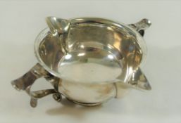 An Arts and Crafts silver two handled and double spouted porringer style bowl,