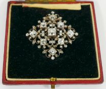 An Edwardian diamond set lozenge-shaped pendant brooch, set with nine square old cut stones,