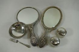 Two silver backed hand mirrors, a small silver pedestal bowl, a cake fork,