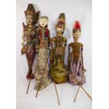 Three traditional painted wooden Indonesian Wayang Golek rod puppets, with fabric dress, onstands,