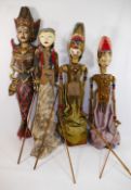 Three traditional painted wooden Indonesian Wayang Golek rod puppets, with fabric dress, onstands,