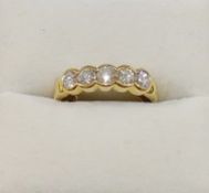 A yellow metal diamond five stone ring, the five round brilliant cut stones each approximately 0.