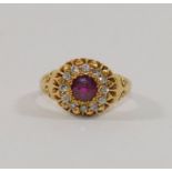 An 18 carat gold almandine garnet and diamond circular cluster ring, Birmingham 1903,