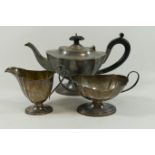 A George IV silver three piece pedestal teaset, Birmingham 1931, of oval form with shaped sides,