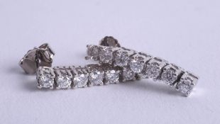 A pair of 18ct and diamond set drop earrings.