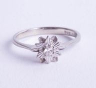 A small 18ct illusion set diamond flower ring, ring size N.