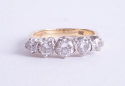 An 18ct five stone diamond ring, size M/N.