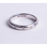 An 18ct white gold and diamond band ring, size M.