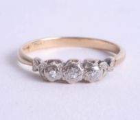 An 18ct three stone diamond ring, size O.