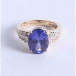 A fine 18k tanzanite and diamond set ring, size O.