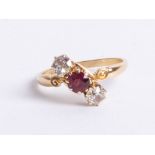An 18ct ruby and diamond three stone ring, size R.