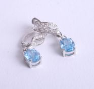 A pair of 18ct diamond and blue topaz earrings.