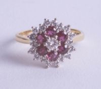 An 18ct ruby and diamond cluster ring, size P.