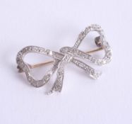 A 9ct white gold and diamond set bow brooch.