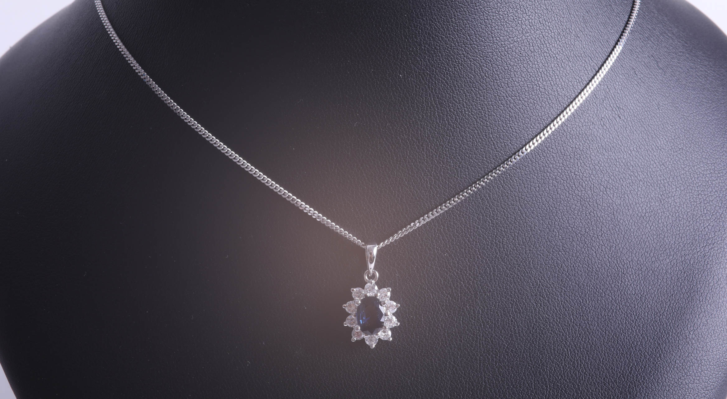 An 18ct white gold diamond and sapphire cluster pendant. - Image 2 of 2