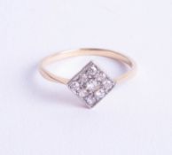 An 18ct (not hallmarked) nine stone diamond dress ring, ring size P.