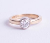 An 18ct single stone diamond ring with rub over setting, approx. 0.50ct, ring size I.