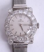 Omega, a fine ladies platinum cocktail wristwatch, the dial set with a band of diamonds approx. 4ct,