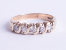 A 9ct gold five stone diamond ring, size R.