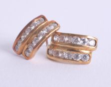 A pair of 18ct and diamond set earrings in yellow gold.