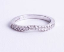 An 18ct white gold 17 stone diamond set half eternity ring, total combined weight 0.17ct, with