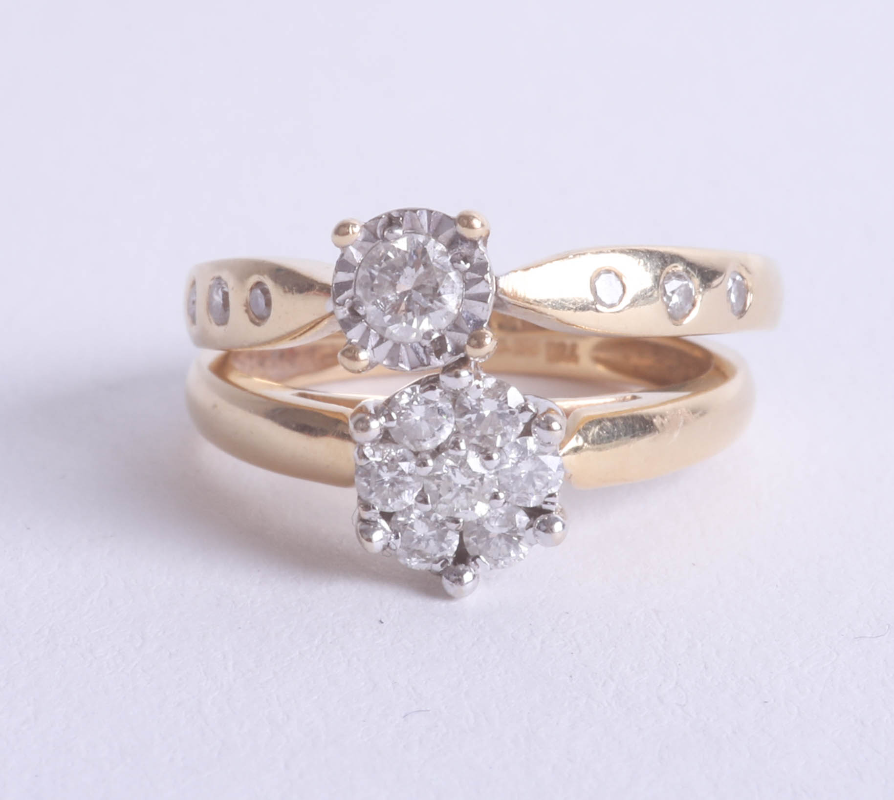 Two 18ct and diamond set dress rings.