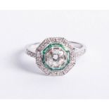 An 18ct diamond and emerald Art Deco style ring, set in white gold, the diamonds are approx