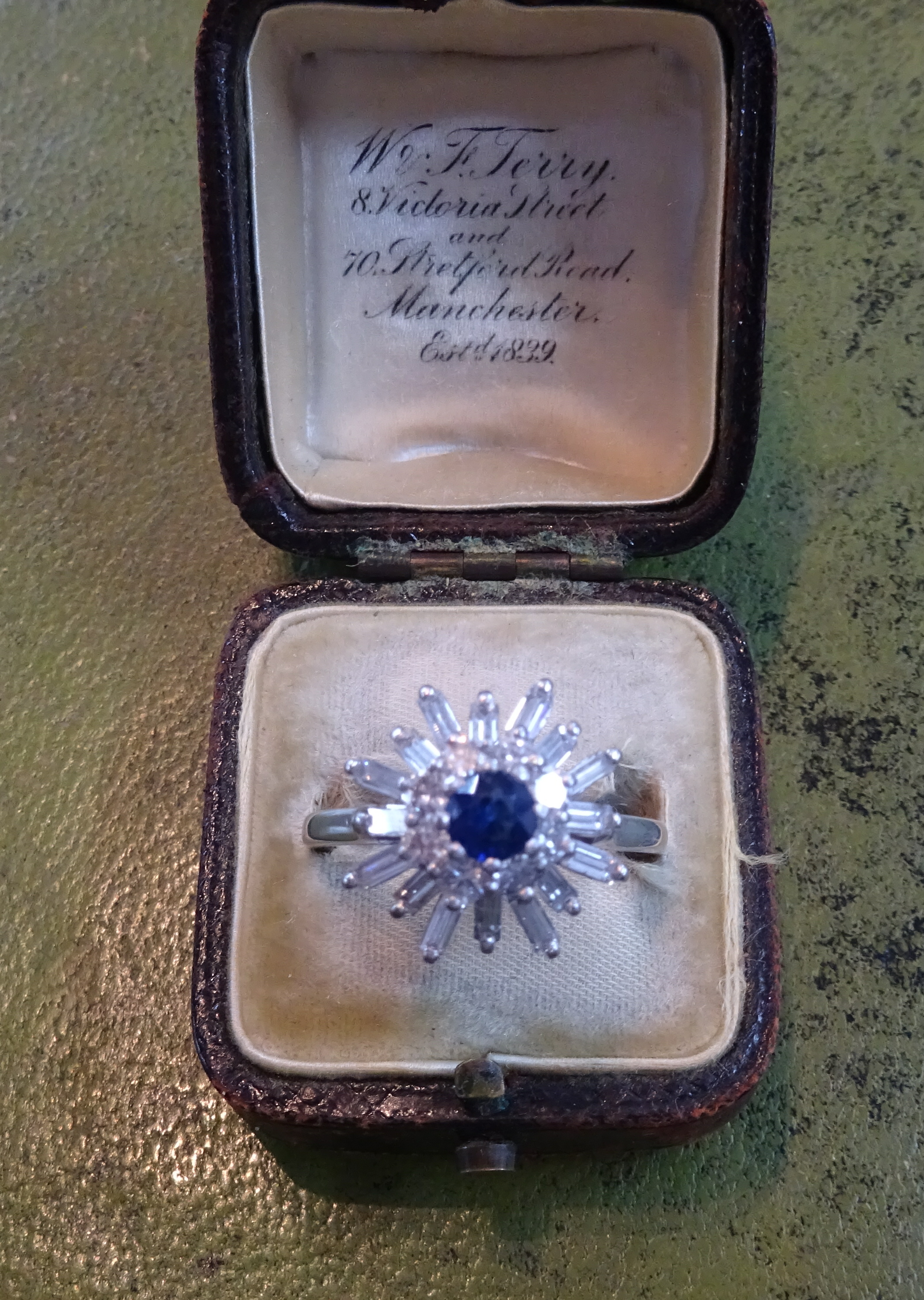 A platinum diamond and sapphire ring set with baguette and round cut diamonds, size U, purchased in