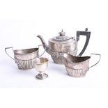 A three piece Geo V silver 'bachelors' tea set, makers mark 'CW' together with a silver egg cup,