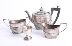 A three piece Geo V silver 'bachelors' tea set, makers mark 'CW' together with a silver egg cup,