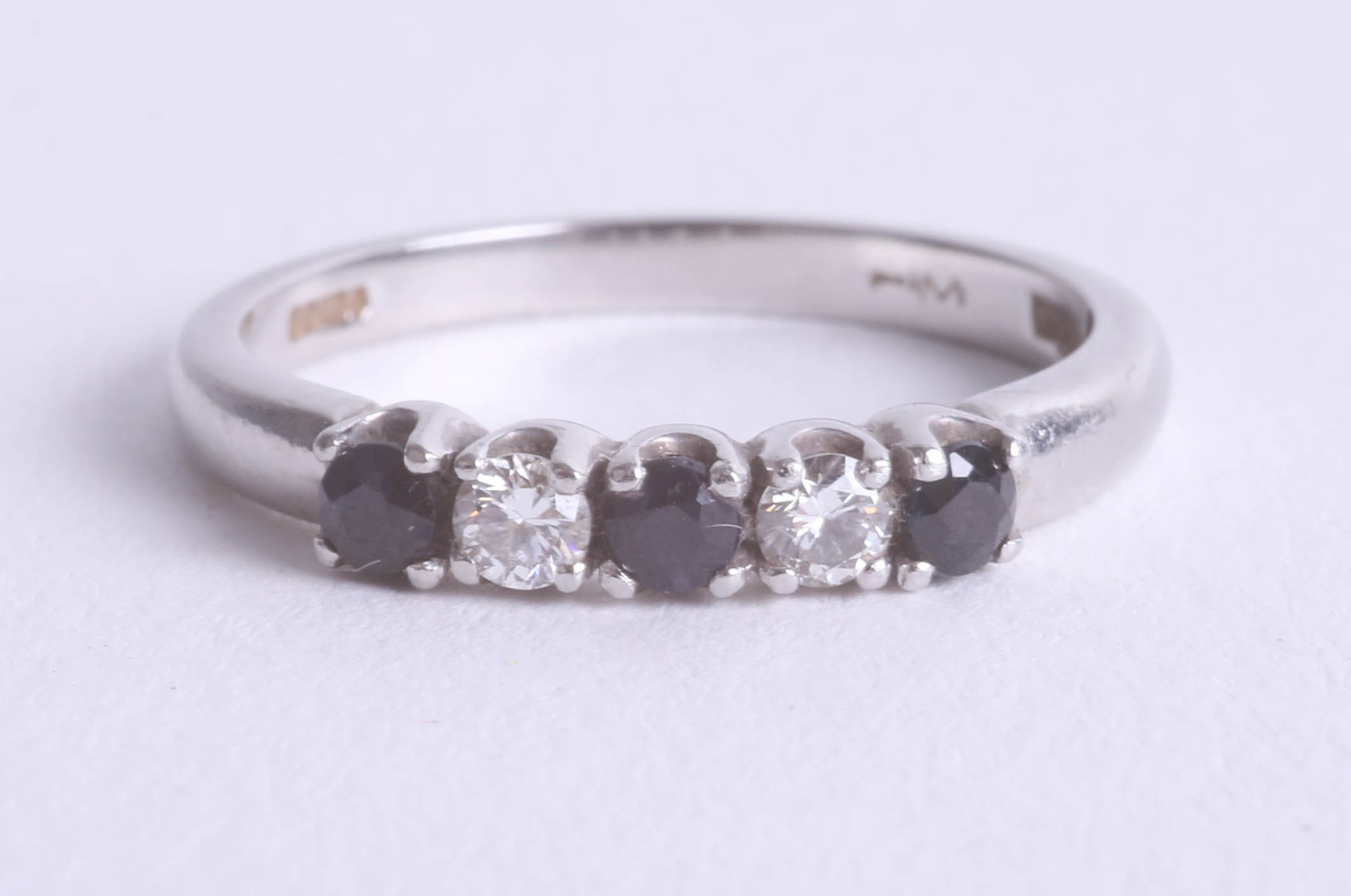 A platinum sapphire and diamond set five stone ring, size N.