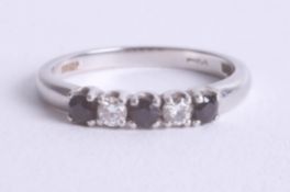 A platinum sapphire and diamond set five stone ring, size N.