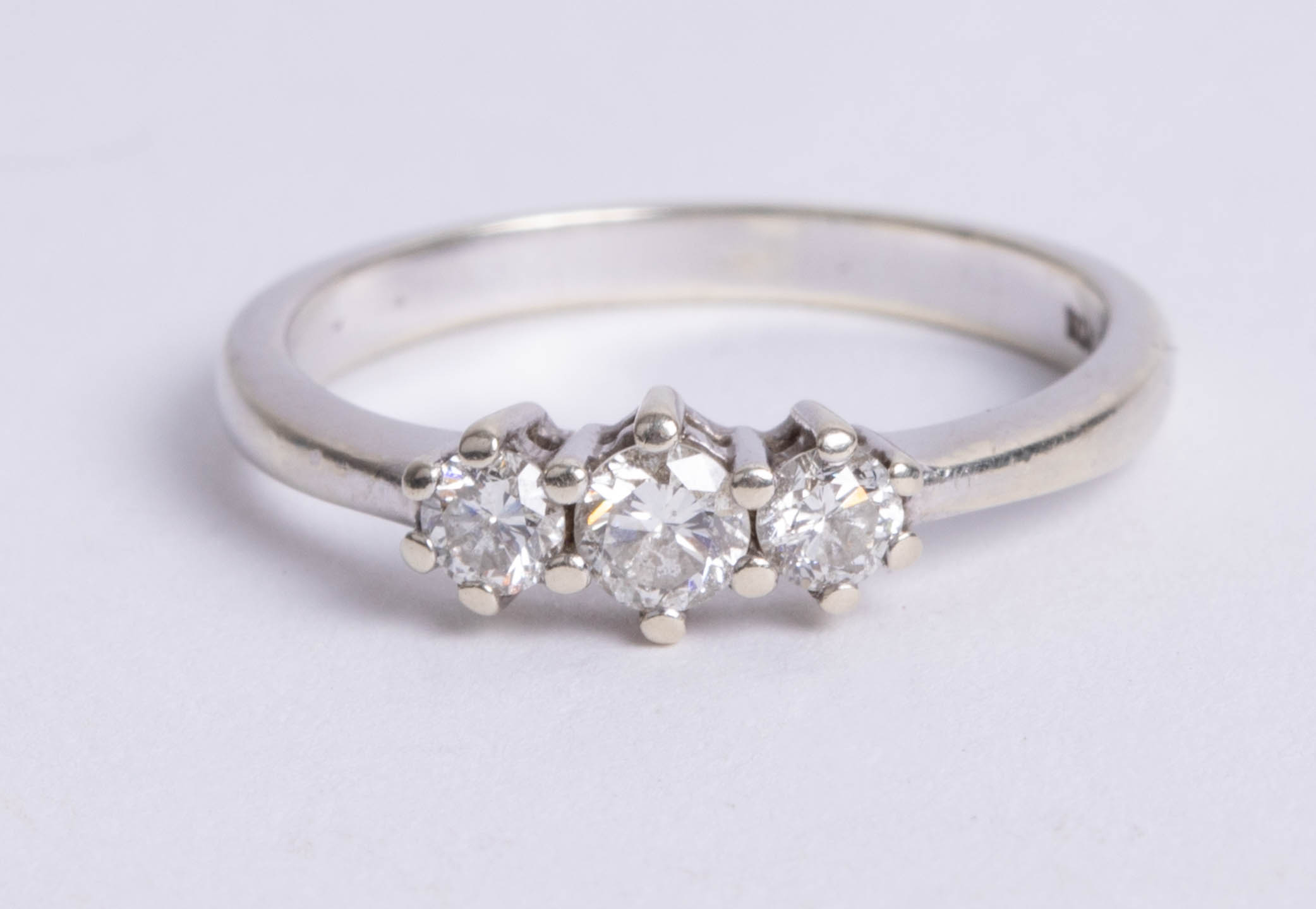 An 18ct white gold and three stone diamond ring, total weight approx. 0.50carat, size P.