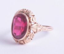 A Russian 14ct rose gold ring set with a red stone, ring size Q.