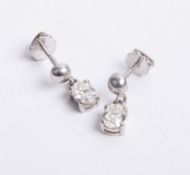 A pair of platinum and diamond drop earrings, set with oval cut diamonds.