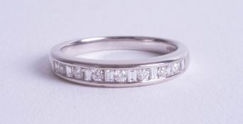 A modern 18ct white gold diamond set eternity ring, size M.